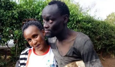 Wanja Mwaura Wanja and Hinga hug in the street.