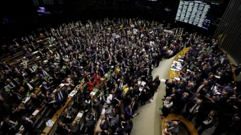 Reuters Members of Congress and supporters of the pension reform bill celebrate the vote in the Chamber of Deputies in Brasilia, July 10, 2019
