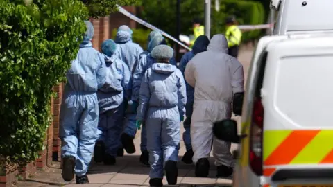 PA Media Forensic investigators on a residential road