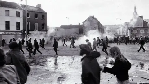 Getty Images Demonstrators run after tear gas explosions on "Bloody Sunday", January 1972 in Northern Ireland.