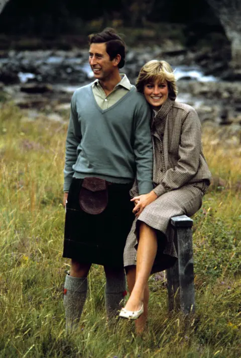 PA Charles and Diana sit together by the banks of a river