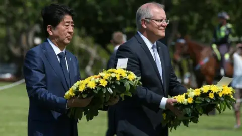 AFP/Getty Images Japanese PM Shinzo Abe and Australian counterpart Scott Morrison lay wreaths in Darwin on Friday