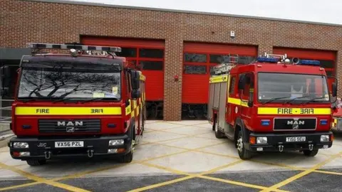 BBC two fire engines outside a fire station