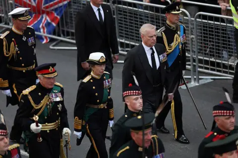 CARL RECINE/Reuters King Charles, Princesss Anne, Prince Andrew and Prince Edward follow the hearse