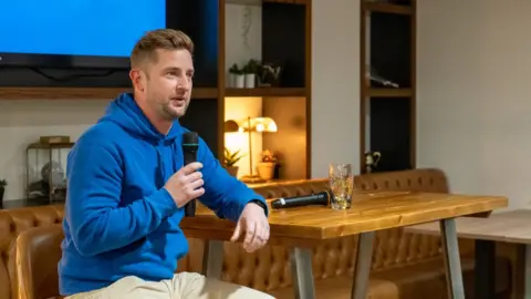 The Burnt Chef Project A man in a blue hoodie