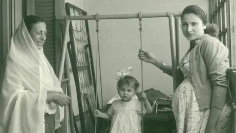 Iman Kishawi Iman Kishawi (center) sits on swing in Gaza in 1959 between her mother (right) and her grandmother (left)