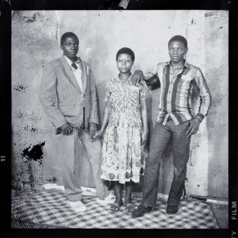 Ssalongo/Mwine Portrait of three people