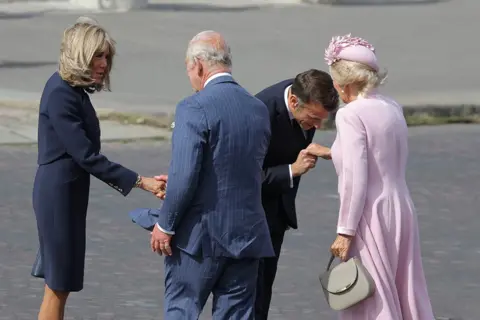 AFP Emmanuel Macron his wife Brigitte Macron welcome King Charles III and Queen Camilla for an official welcoming ceremony at the Arc de Triomphe