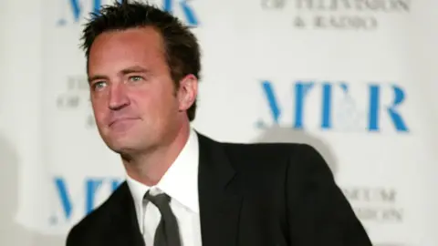 Getty Images Matthew Perry from the TV series Friends wearing a suit and tie