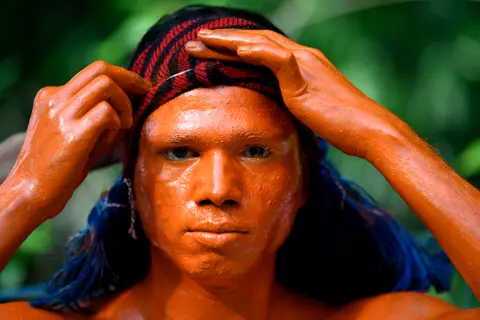 Syed Mahamudur Rahman / Getty Images A Hindu devotee participates in the Lal Kach (Red Glass) festival in Munshiganj, Dhaka, Bangladesh, on 13 April 2023.