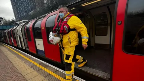 RNLI Nick Walton getting of a tube train