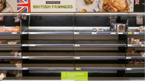 Getty Images Empty shelves in an ASDA store on October 9, 2021 in Cardiff, Wales.