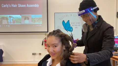 Carly having her hair cut for charity