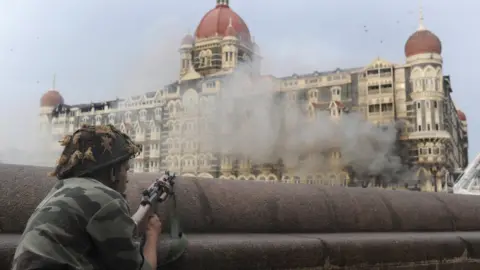 Getty Images This photograph taken on November 29, 2008 shows an Indian soldier aiming his weapon towards The Taj Mahal Hotel in Mumbai.