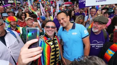 PA Media A Pride-goer grabs a selfie with taoiseach (Irish prime minister) Leo Varadkar
