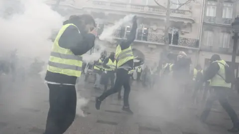 AFP Image shows a protester throwing a tear gas canister.