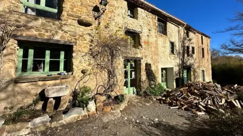 An exterior of a house in France with wood outside