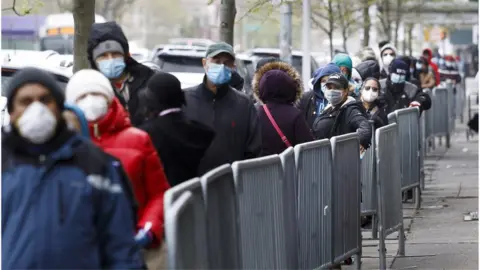 EPA People wait at a food bank in NY