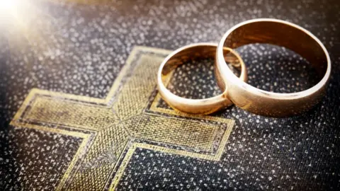 Getty Images Wedding rings on a Bible