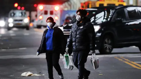 Getty Images People walk through the streets of Brooklyn which has seen an upsurge of coronavirus patients