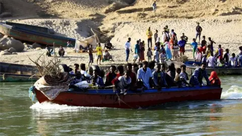 Rex Features Ethiopians who fled the ongoing fighting in Tigray region, use boats to cross the Setit river on the Sudan-Ethiopia border in Hamdayet village in eastern Kassala state, Sudan November 22, 2020
