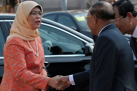 AFP/Getty Images Singaporean Member of Parliament (MP) and National Trades Union Congress Assistant Secretary-General, Halimah Yacob (L) shakes hands with Cambodian President of National Assembly Heng Samrin (R) upon her arrival at the National Assembly building in Phnom Penh on 7 May 2015.