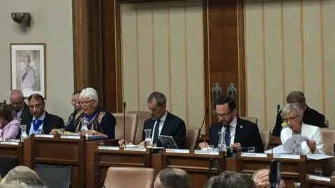 BBC Nathan Elvery sits next to council leader Louise Goldsmith at a full council meeting in July 2019