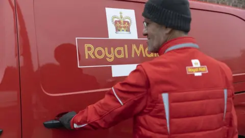 Getty Images A Royal Mail worker in front of his van