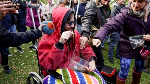 Reuters People contribute cannabis for a communal joint in Canada