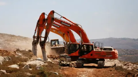 Reuters Diggers break ground for the new Jewish settlement of Amichai in the occupied West Bank (20 June 2017)