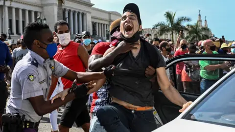 Getty Images A man is arrested during a demonstration against the government of Cuban President Miguel Diaz-Canel in Havana, 11 July 2021