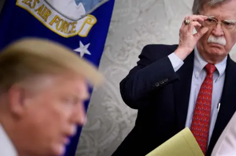 AFP National Security Adviser John Bolton listens while President Donald Trump speaks at the White House on 13 May 2019