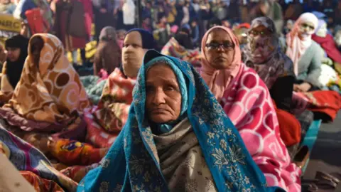 Getty Images Women protesters along with their children participate in a sit-in against National Register of Citizens (NRC) and recently passed Citizenship Amendment Act (CAA), at Shaheen Bagh