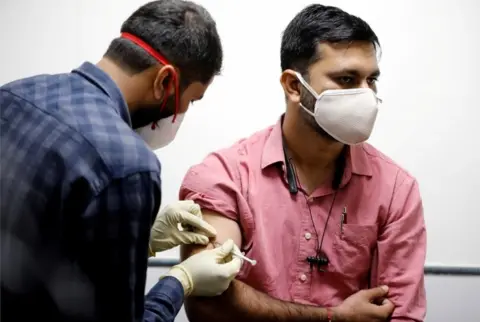 Reuters A medic administers COVAXIN, an Indian government-backed experimental COVID-19 vaccine, to a health worker during its trials, at the Gujarat Medical Education ^ Research Society in Ahmedabad, India, November 26, 2020