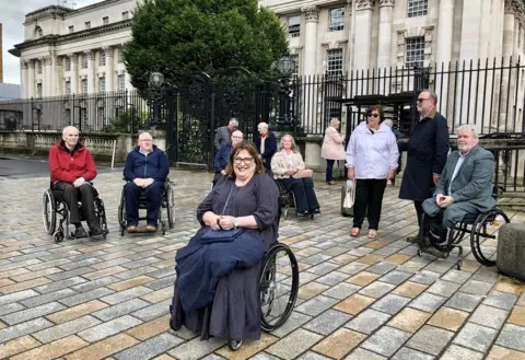 PA Media Jennifer McNern (centre) outside Belfast High Court