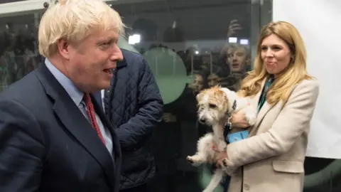 PA Media Boris Johnson and Carrie Symonds with their rescue dog