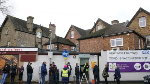 PA Media People queuing for booster jabs at Sevenoaks Pharmacy in Kent