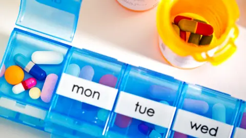 Getty Images A pill box and pills