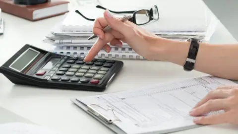 Woman using calculator