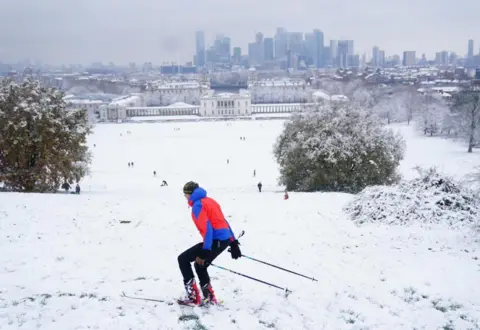 Victoria Jones/PA Wire A person skis in the snow at Greenwich Park, London