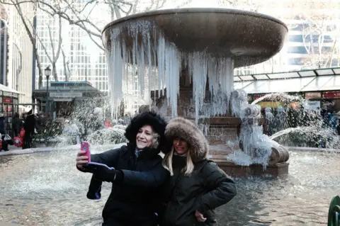 Getty Images New York tourists take selfie in front of frozen fountain