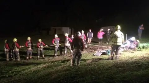 Tolvaddon Community Fire Station Firefighters holding line in dark field