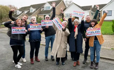 People's Postcode Lottery Winners of the People's Postcode Lottery celebrating with their cheques