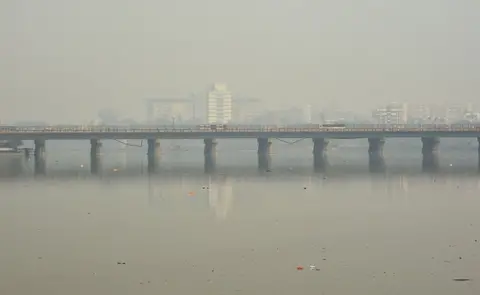 AFP Traffic is pictured on a bridge over the Sabarmati River during heavy smog conditions in Ahmedabad on February 5, 2019.