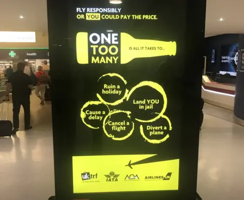 One Too Many One Too Many campaign on screen at Manchester airport