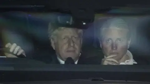 EPA Prime Minister Boris Johnson leaves the Houses of Parliament in the back of a car after winning a vote of no confidence