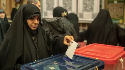 Getty Images Iranian people cast their votes for 12th term of the parliamentary elections and the 6th term of the Assembly of Leadership Experts at a polling station