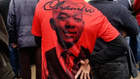 Getty Images A supporter wears a t-shirt showing the face of Movement for Democratic Change Alliance leader Nelson Chamisa at an election rally on July 7, 2018 in the mining town of Zvishavane, Midlands province Zimbabwe