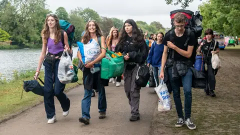 Getty Images Festivalgoers heading to the festival ground