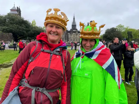 PA Media Chloe Fisher (left) and Kasia Slany, travelled from London to Wales to watch the coronation in the grounds of Cardiff Castle